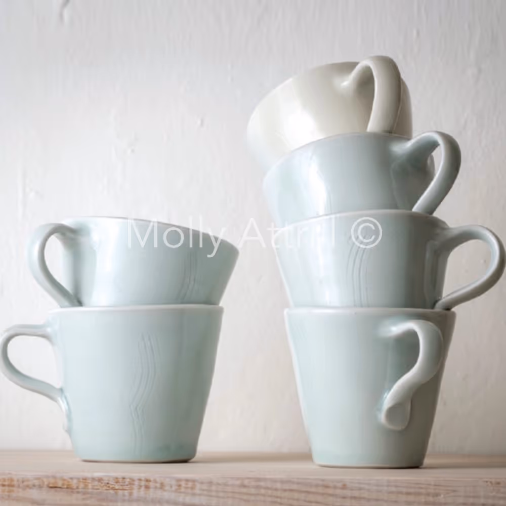 Pottery mugs in soft duck egg green and cream