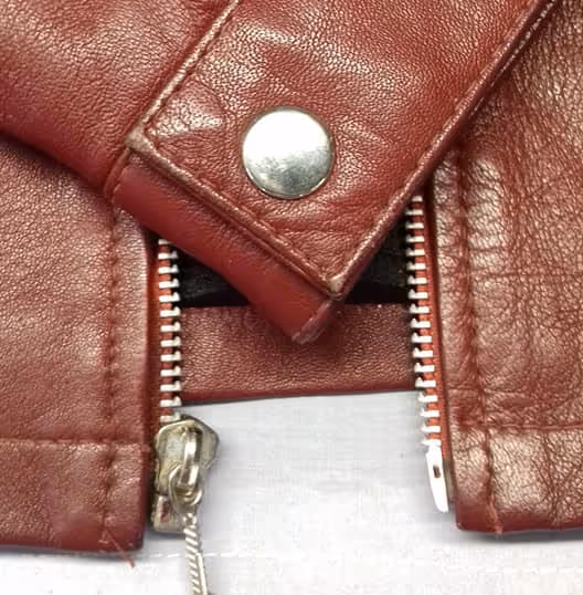 Cuff and front zip of a red leather jacket