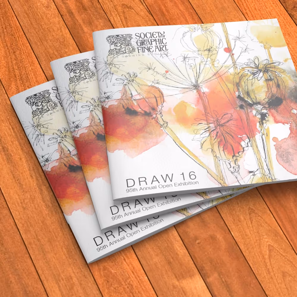 Three brochures upon a wooden table