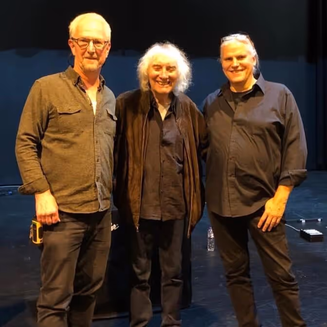 3 singers posing for a photo