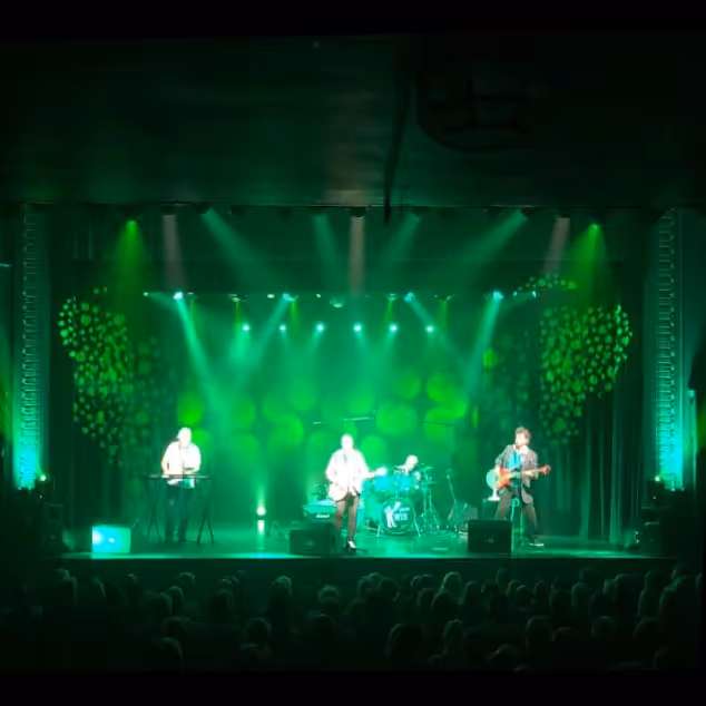 A concert stage illuminated in green lights