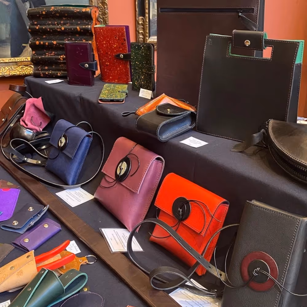 Handcrafted leather bags and purses on display at a show