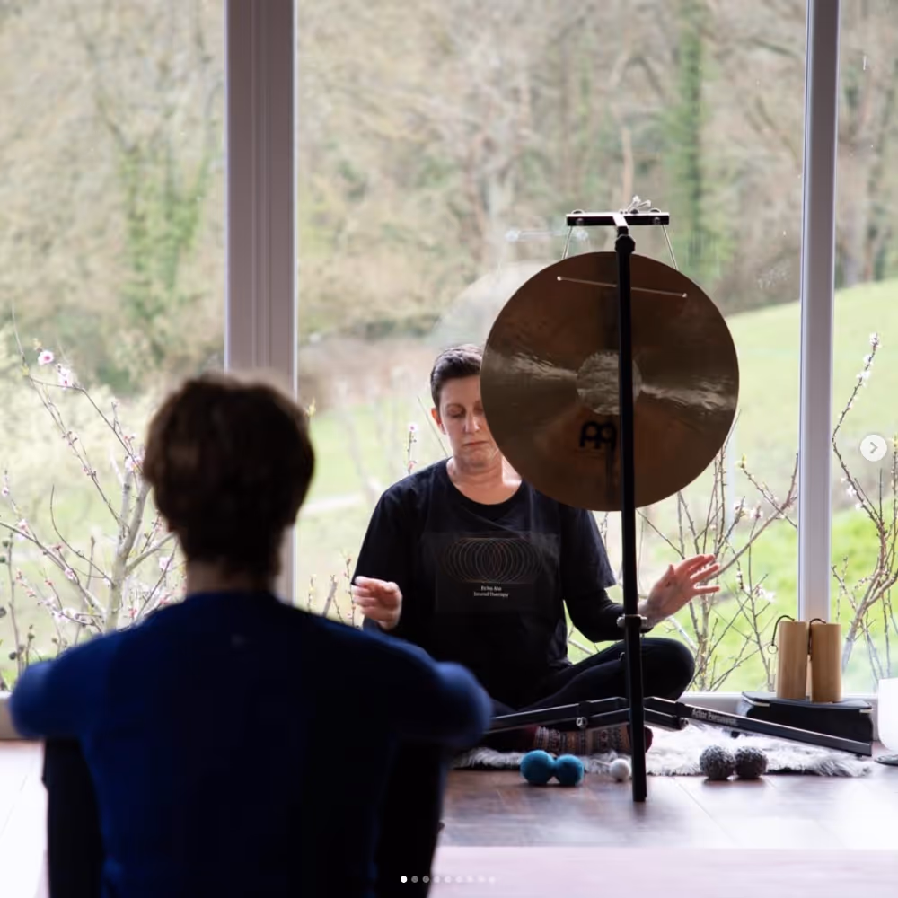 Lady performing a sound bath