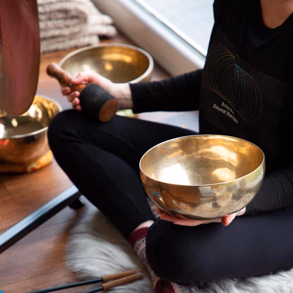Lady holding a brass singing bowl