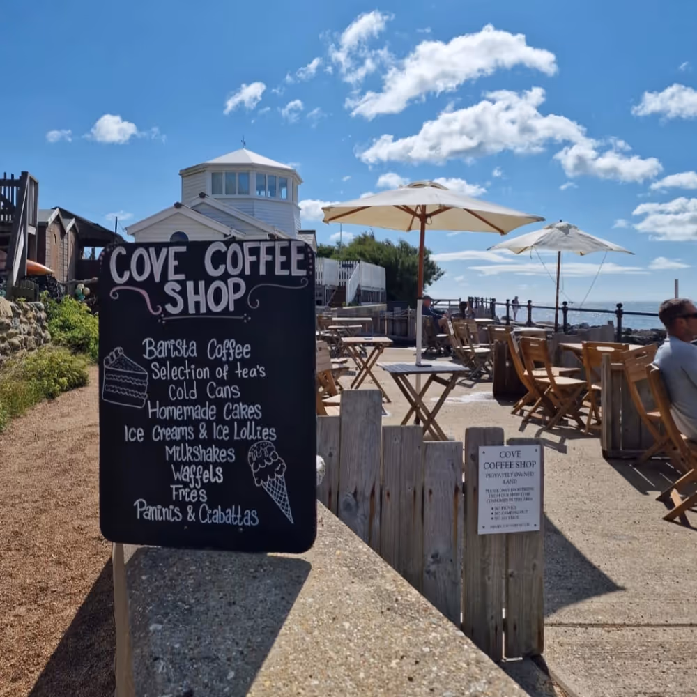 A coffee shop blackboard by the beach