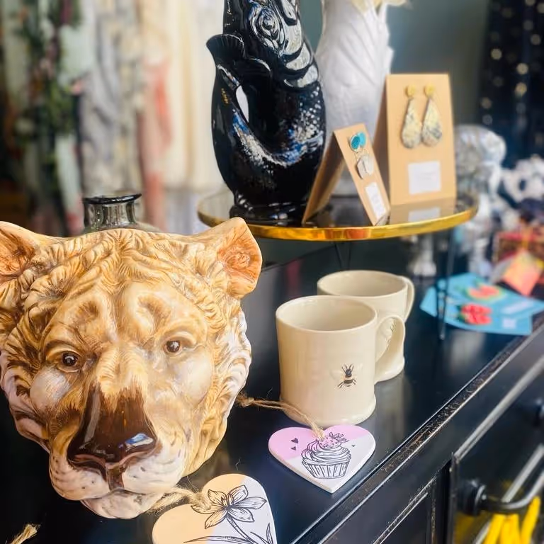 Ceramic tiger's head and other ornaments for sale in a ladies boutique