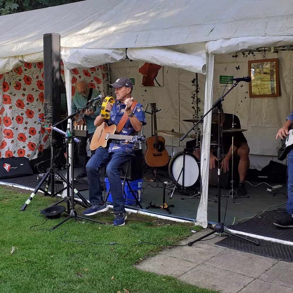 A live band playing music in a marquee