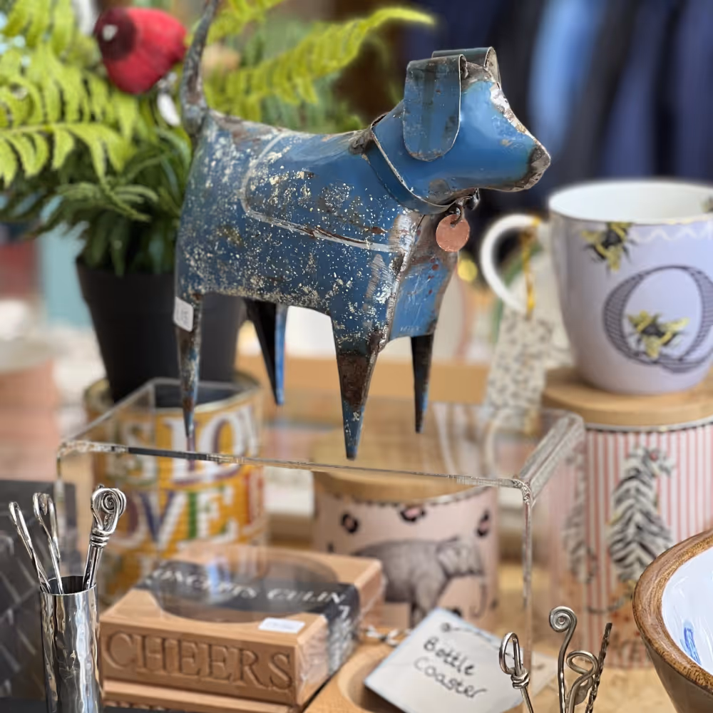 A tin dog and other gifts in a shop