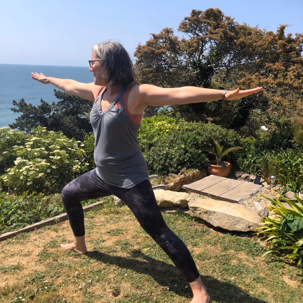 A lady in a warrior yoga pose