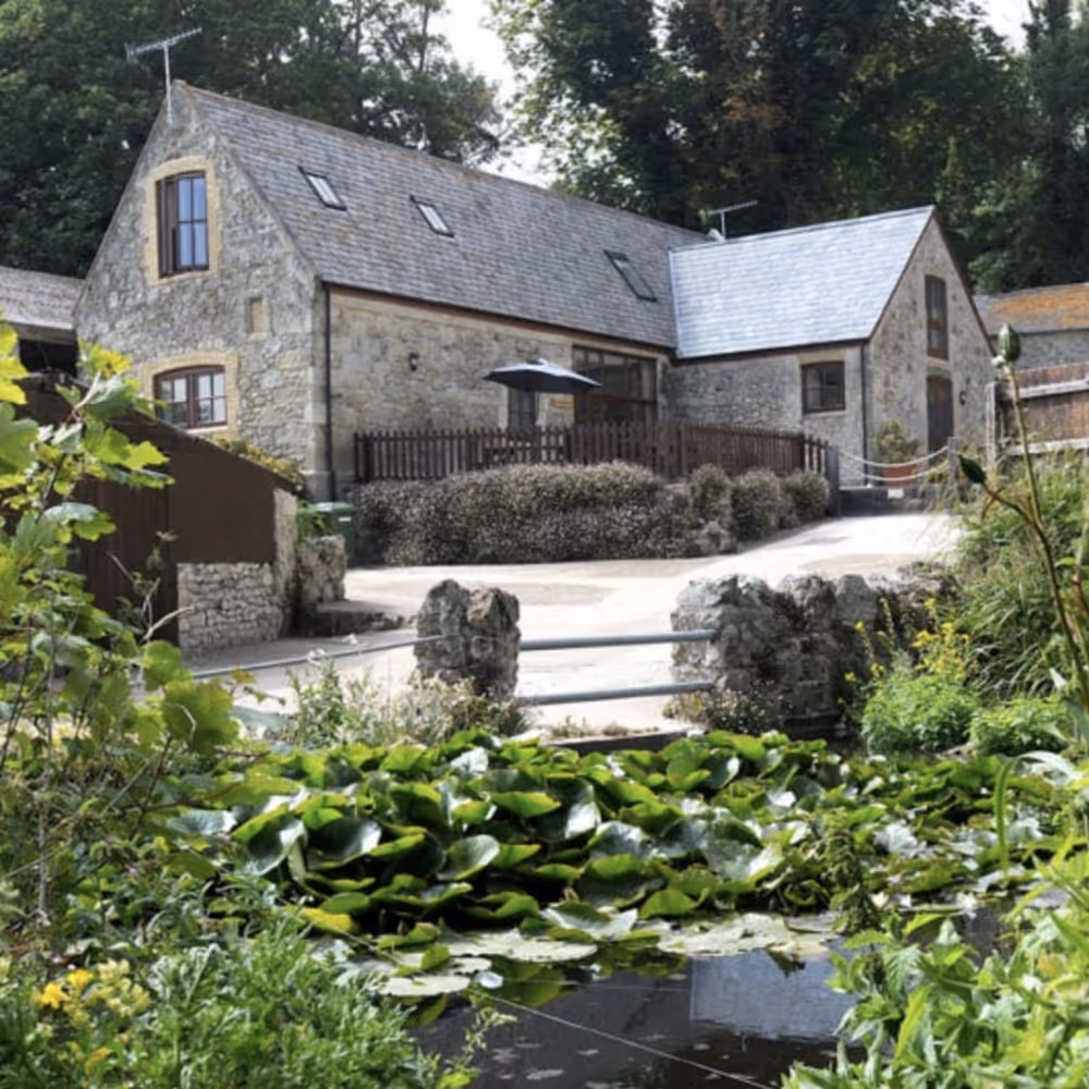 A converted stone barn in a courtyard
