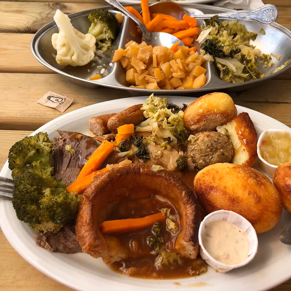Two plates of roast dinner with all the trimmings