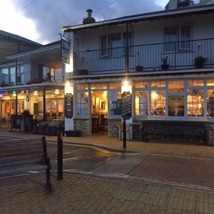 A beachside pub illuminated at night