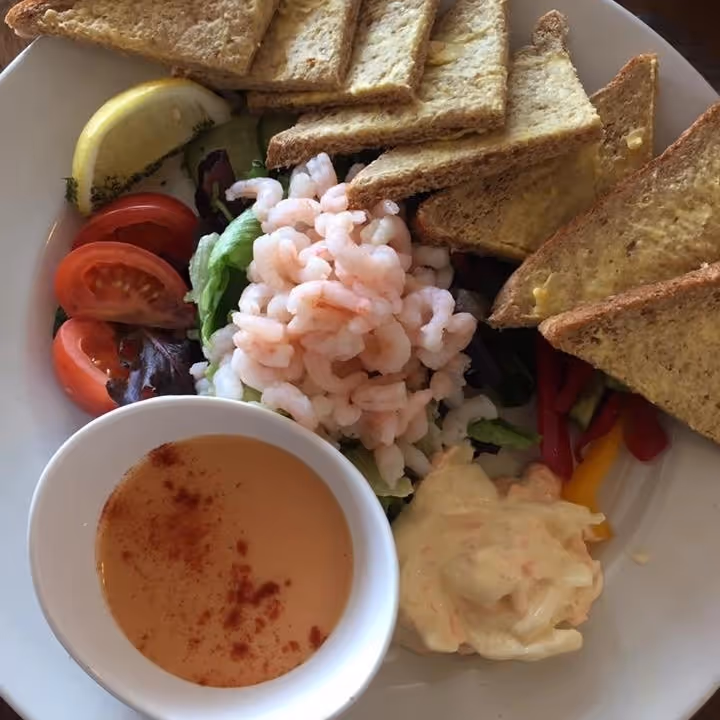 A prawn cocktail starter with marie rose sauce and slice buttered bread