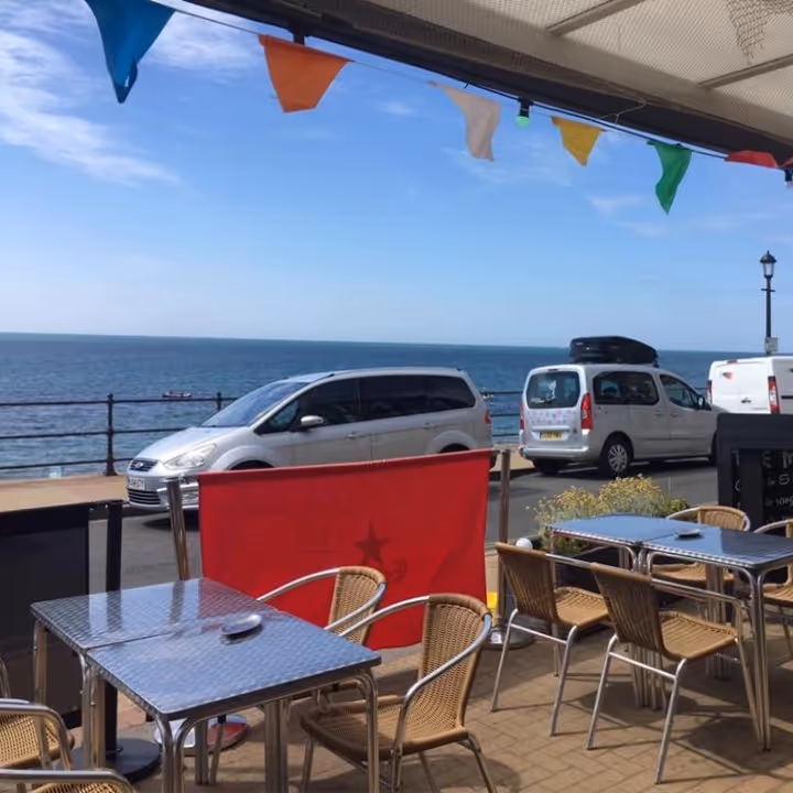 A pub's outside eating area overlooking the sea