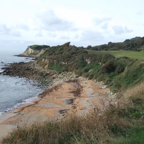 Looking down to an isolated beach from a cliff top path