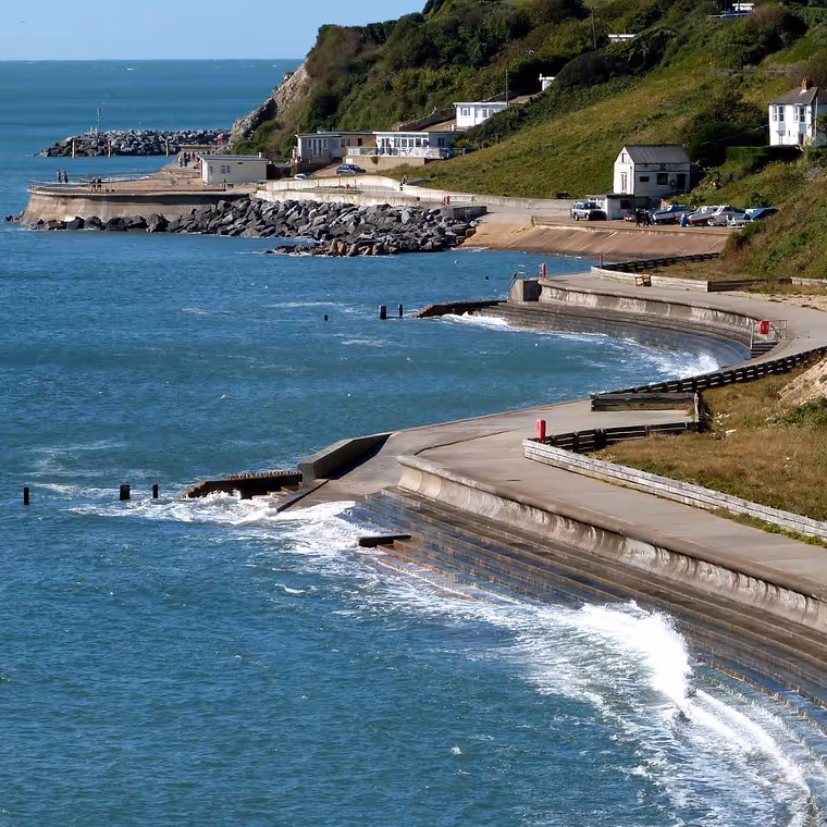 A winding concrete esplanade on the shore