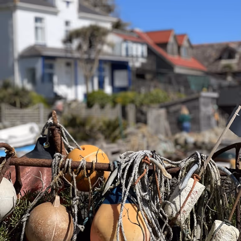 Fishermen's buoys with beachside homes in the background