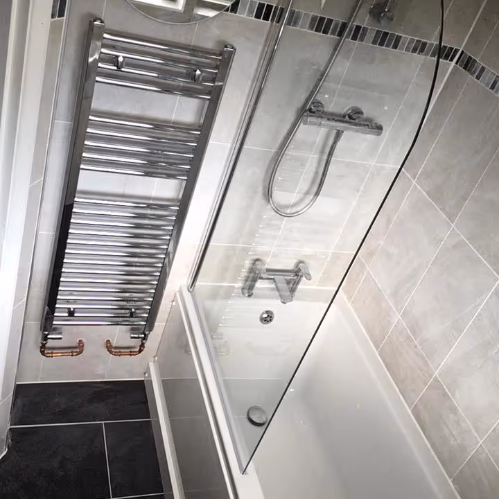 A bathroom with grey tiling