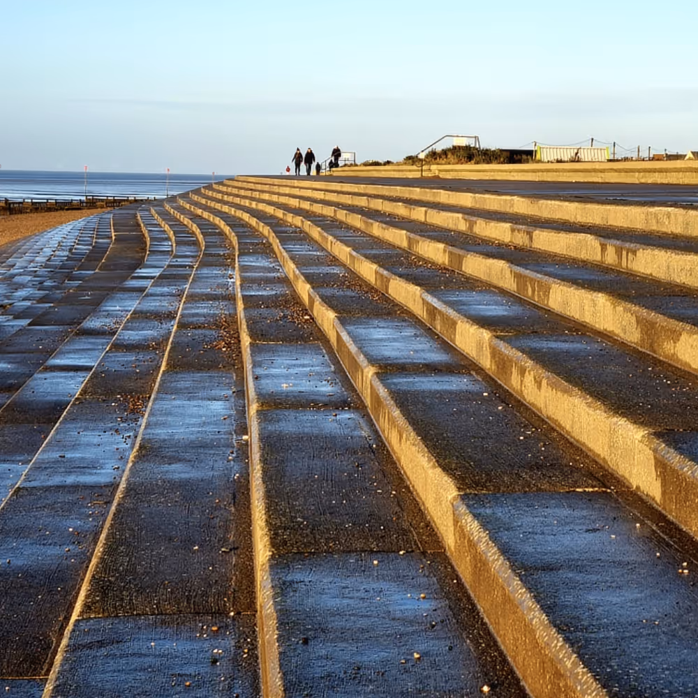 Steps down to a beach at dusk