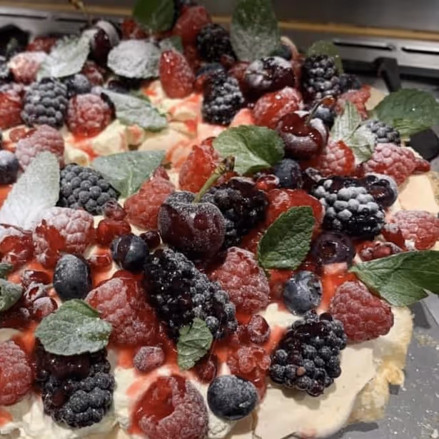 A cheesecake decorated with summer berries