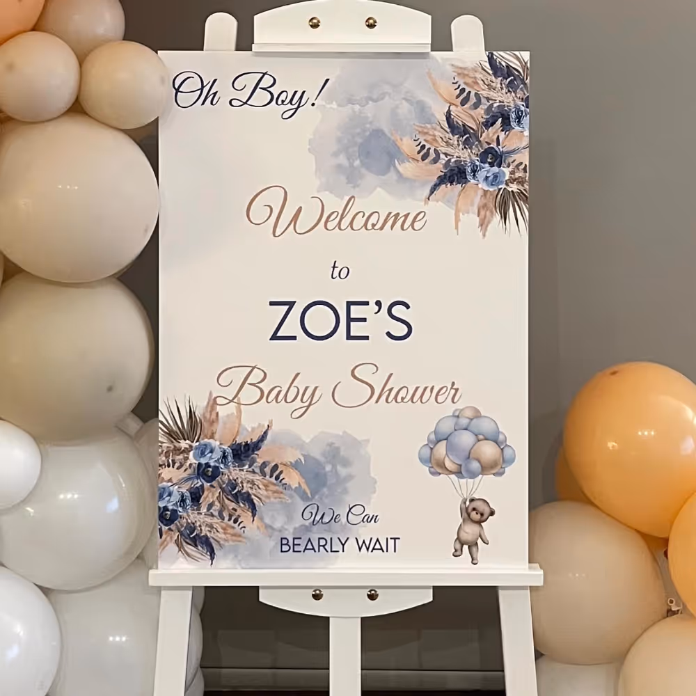 A welcome board with balloons at a baby shower