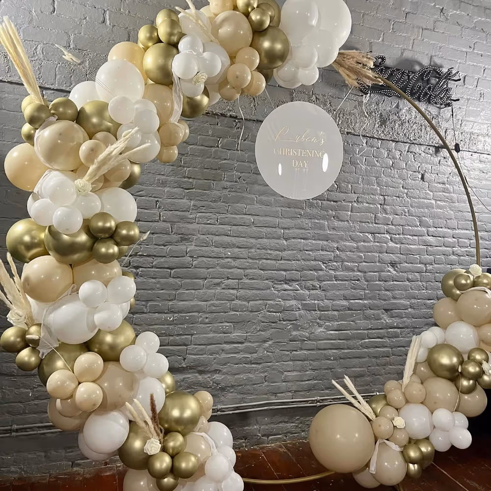 A giant hoop of cream, white and gold balloons for a baby's christening