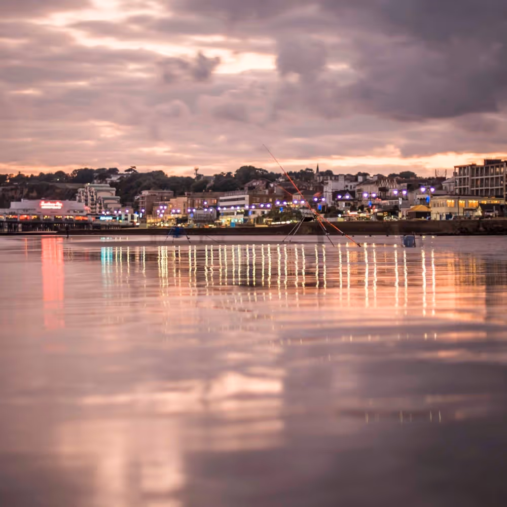 Looking to the shore of a town a sunset