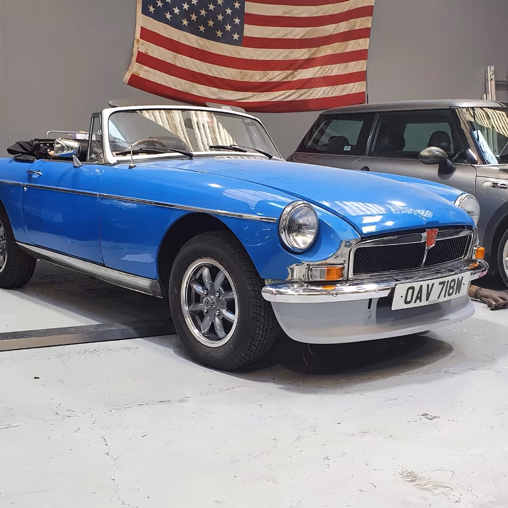 An blue MG sports car having body repairs