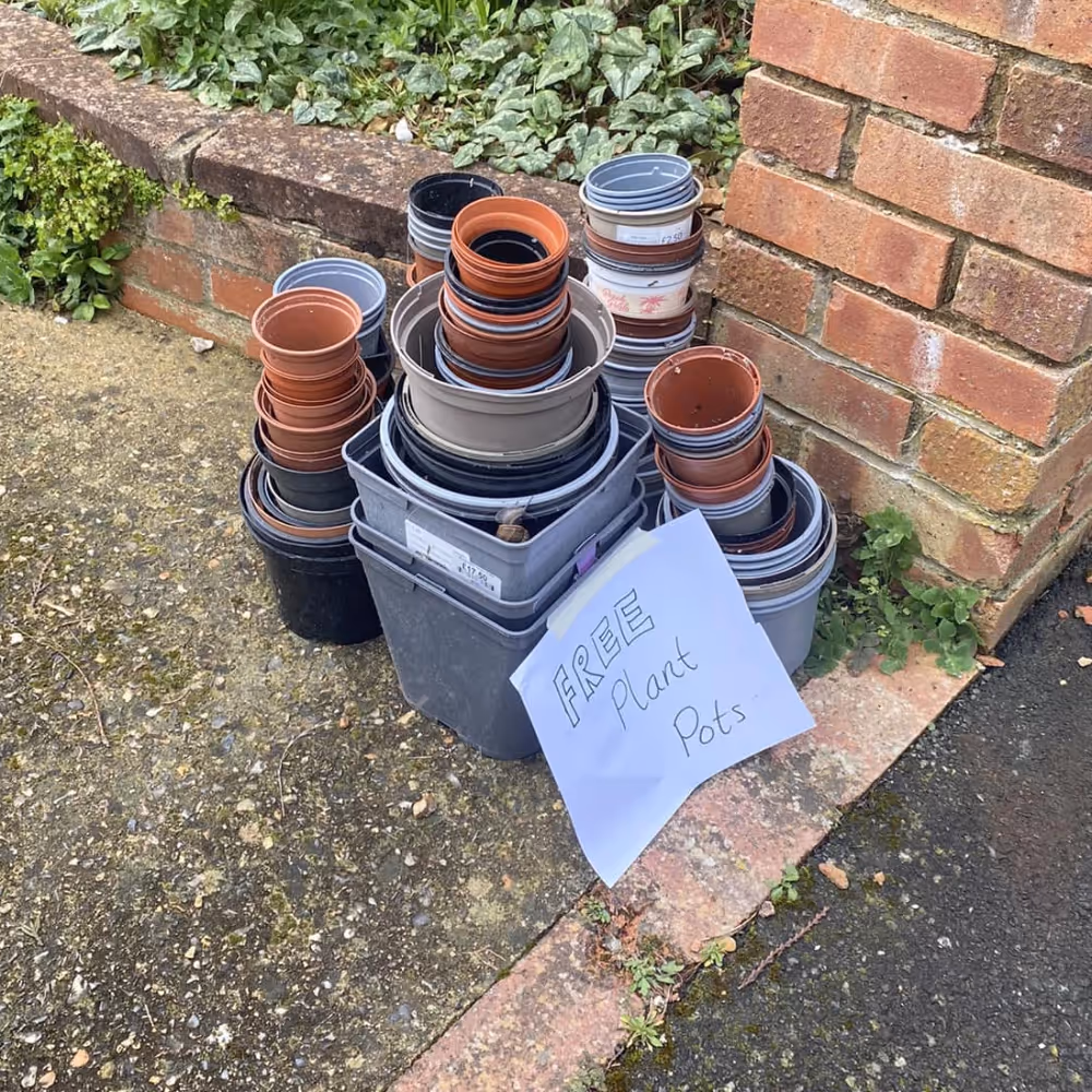 A pile of plastic plant pots