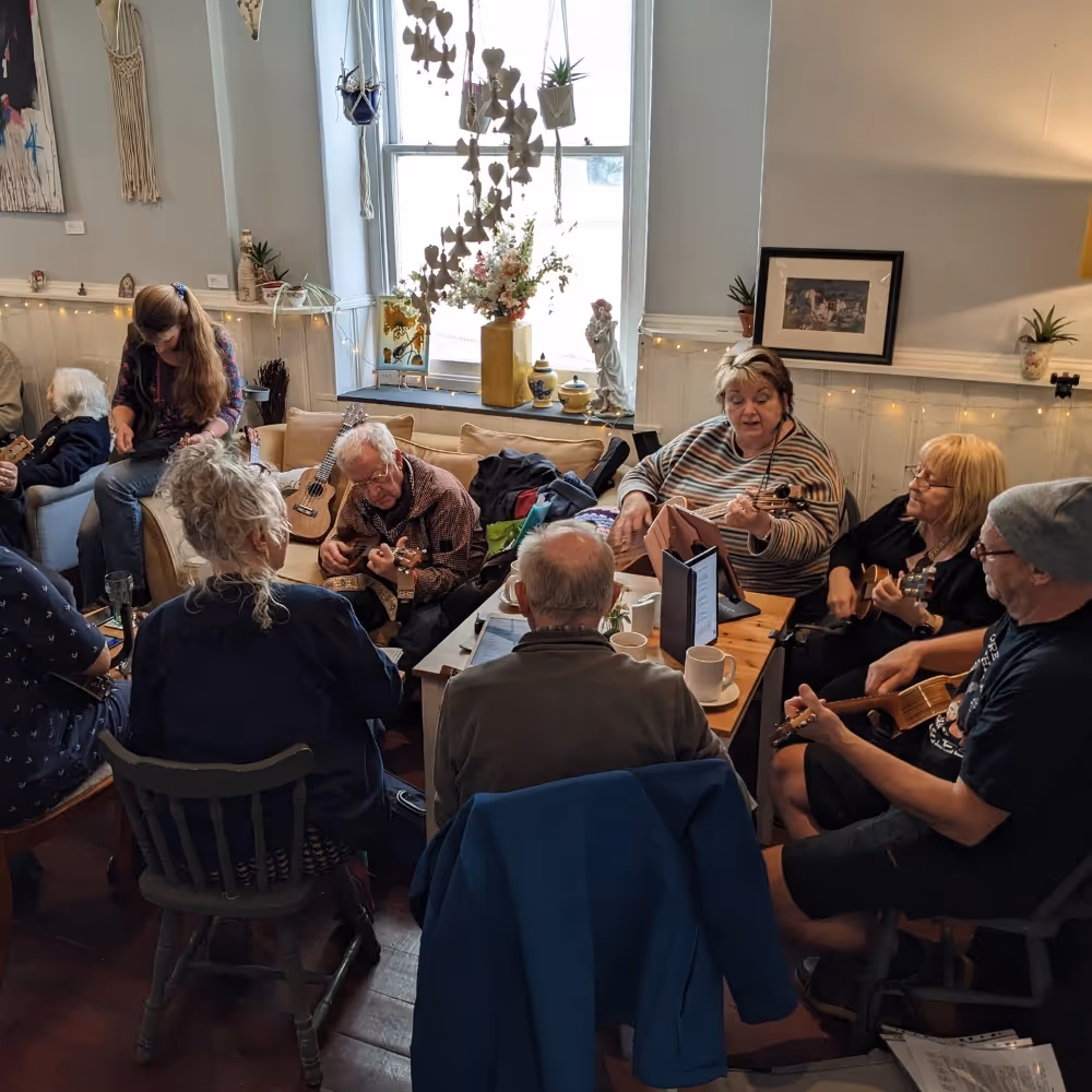 A group of ukulele players in a cafe