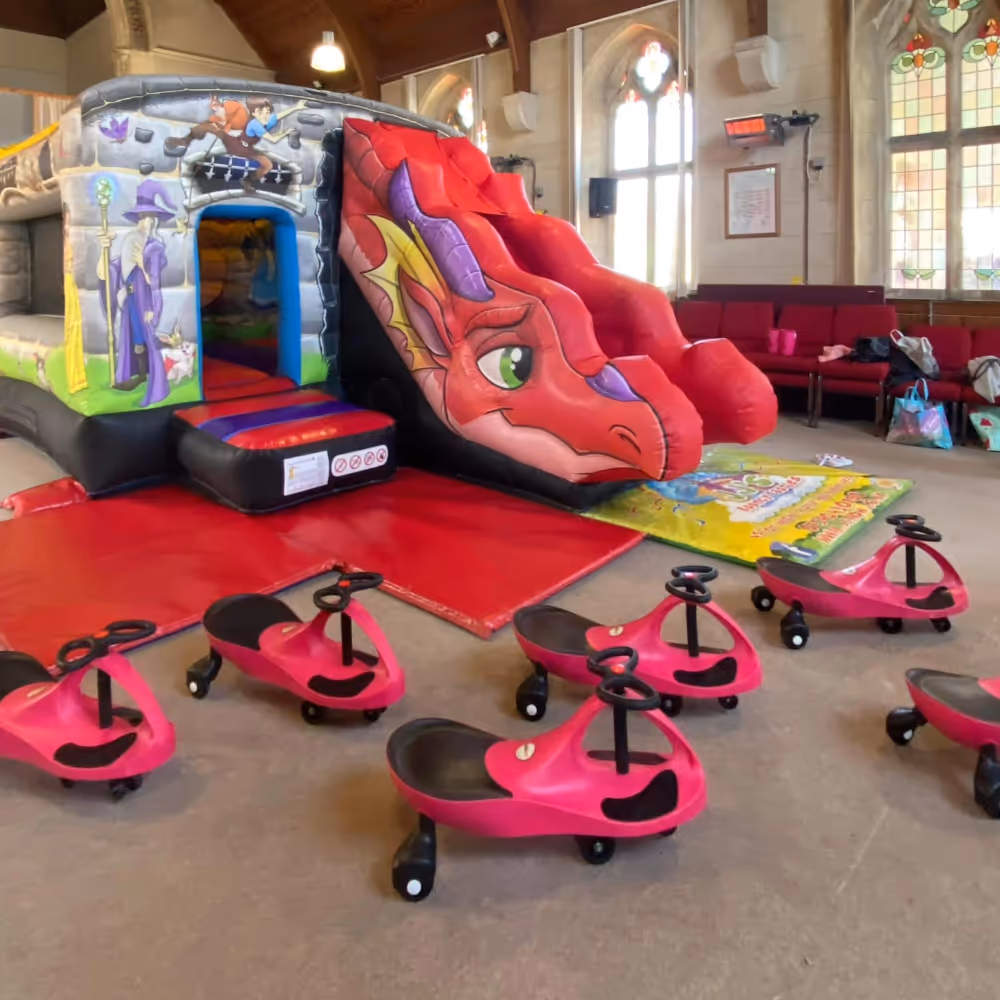Pink bouncy castle inside a church hall
