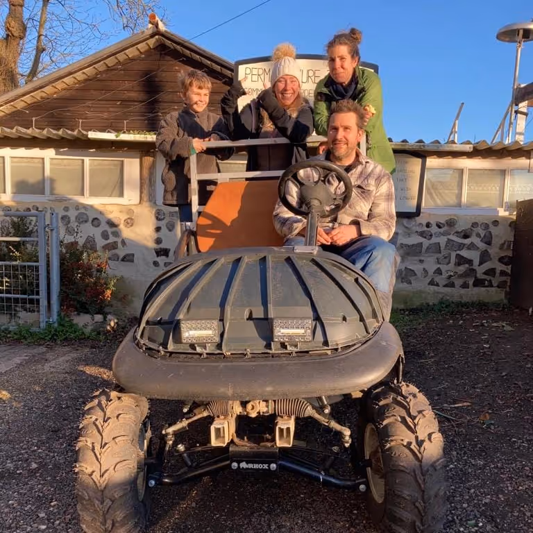 A family sitting on their tractor