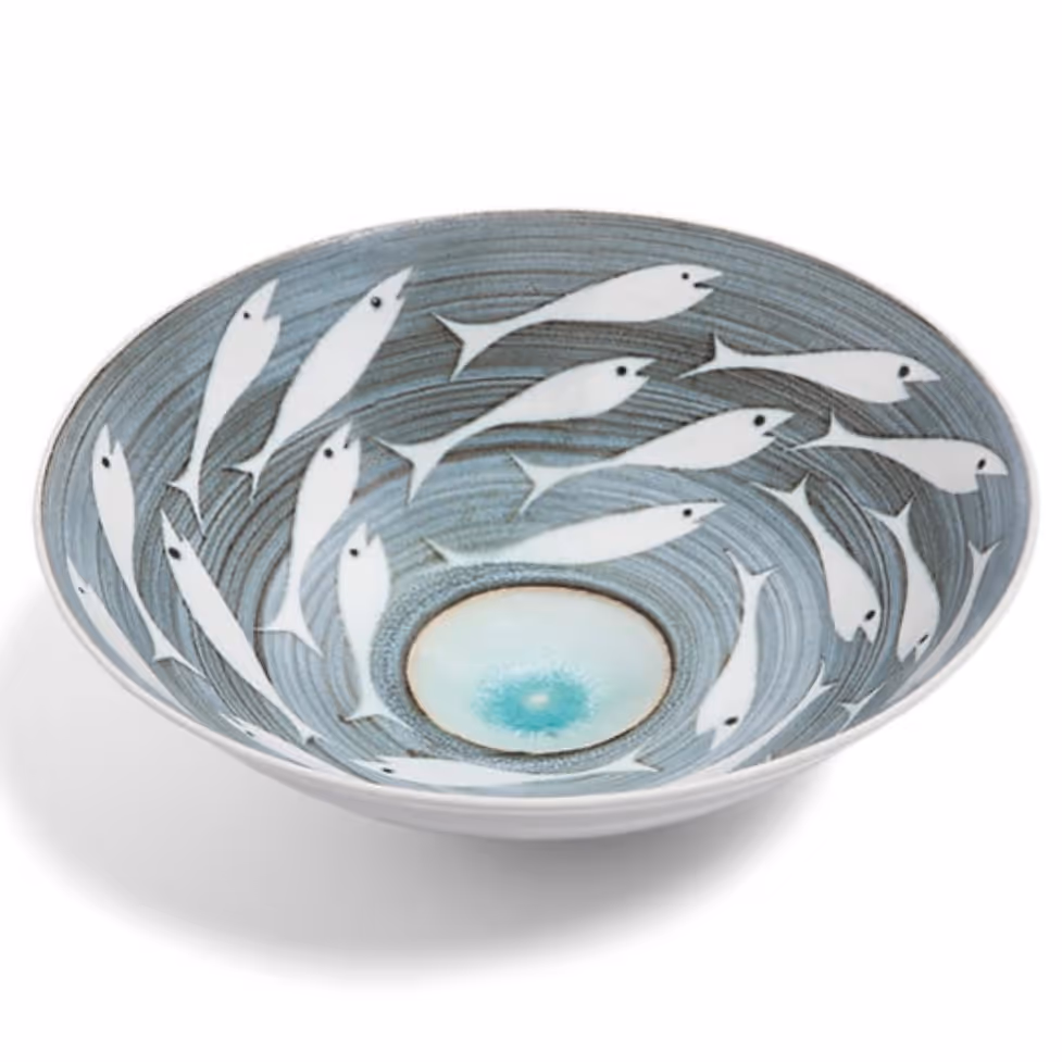 A stoneware bowl with a blue-grey and white glaze and a fish pattern