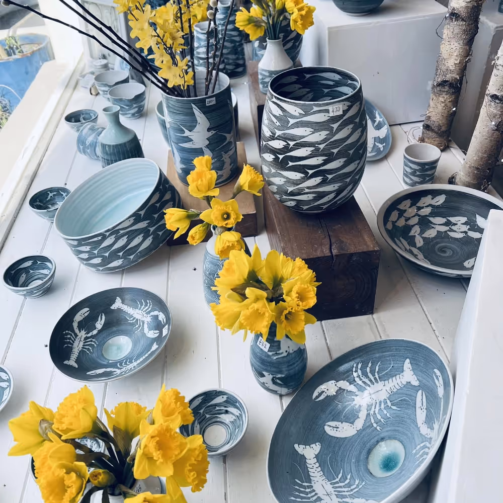 A selection of stoneware bowls and vases in blue grey tones