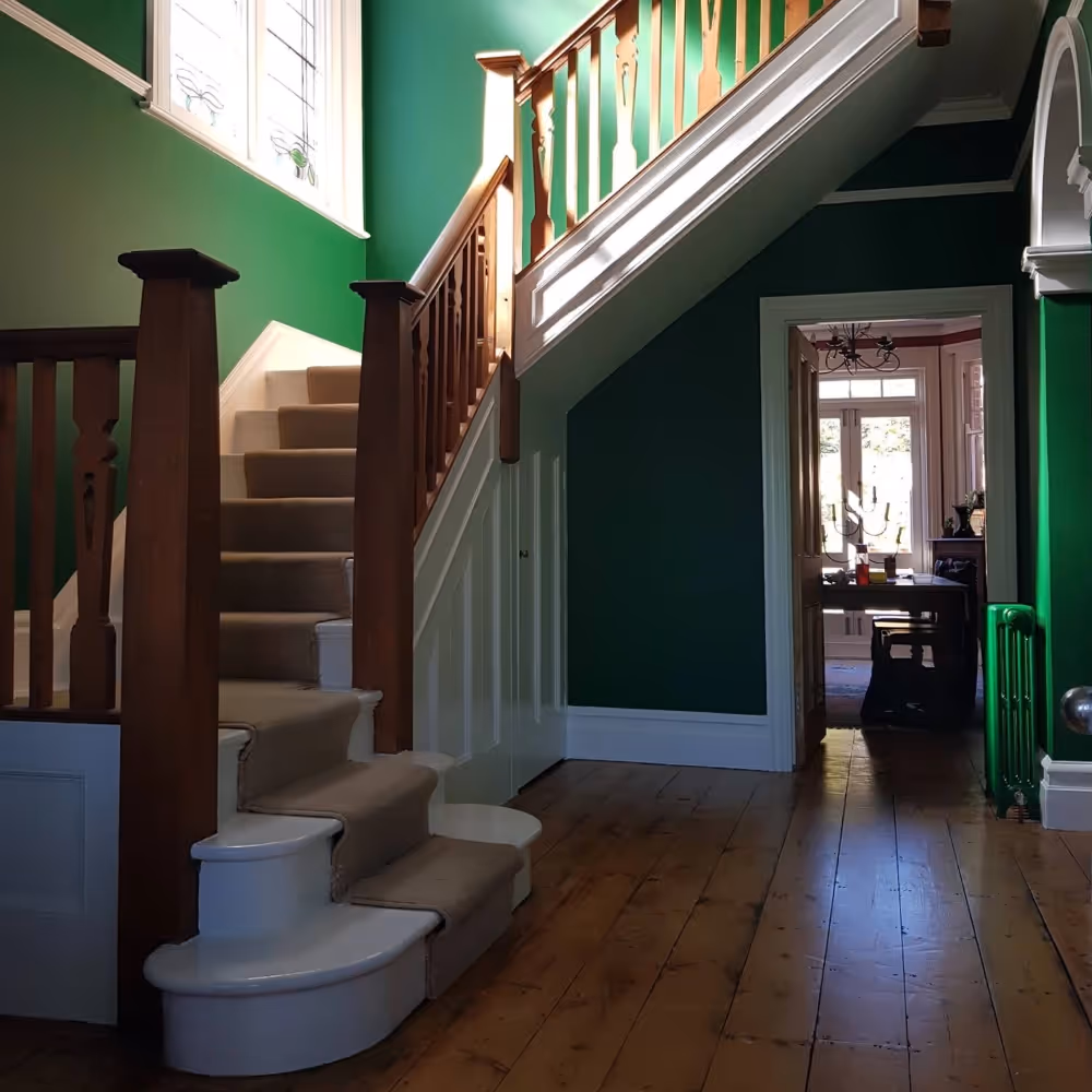 A spacious entrance hall painted bright green