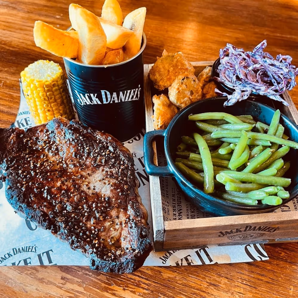 Steak and fries served with pickles