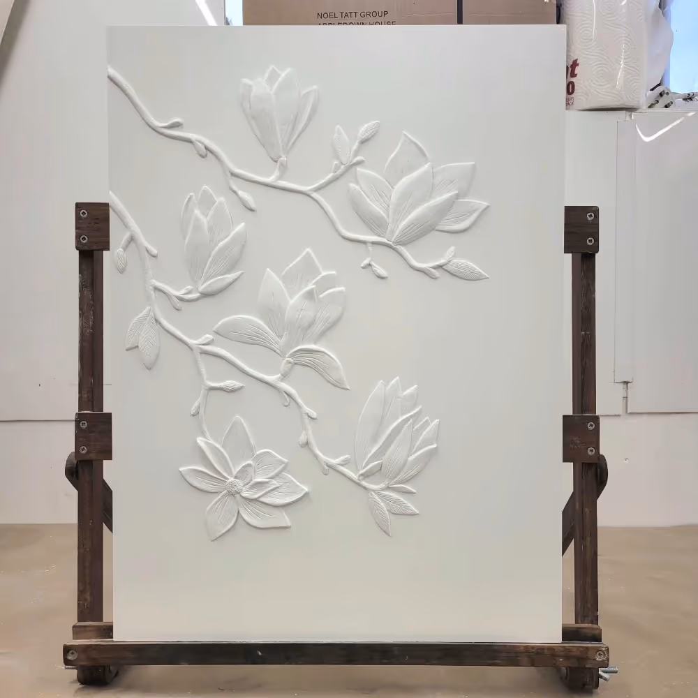 Plaster relief artwork on an easel