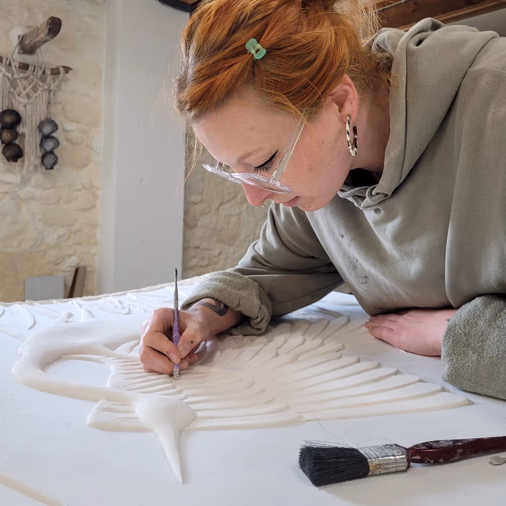A plaster relief artist at work