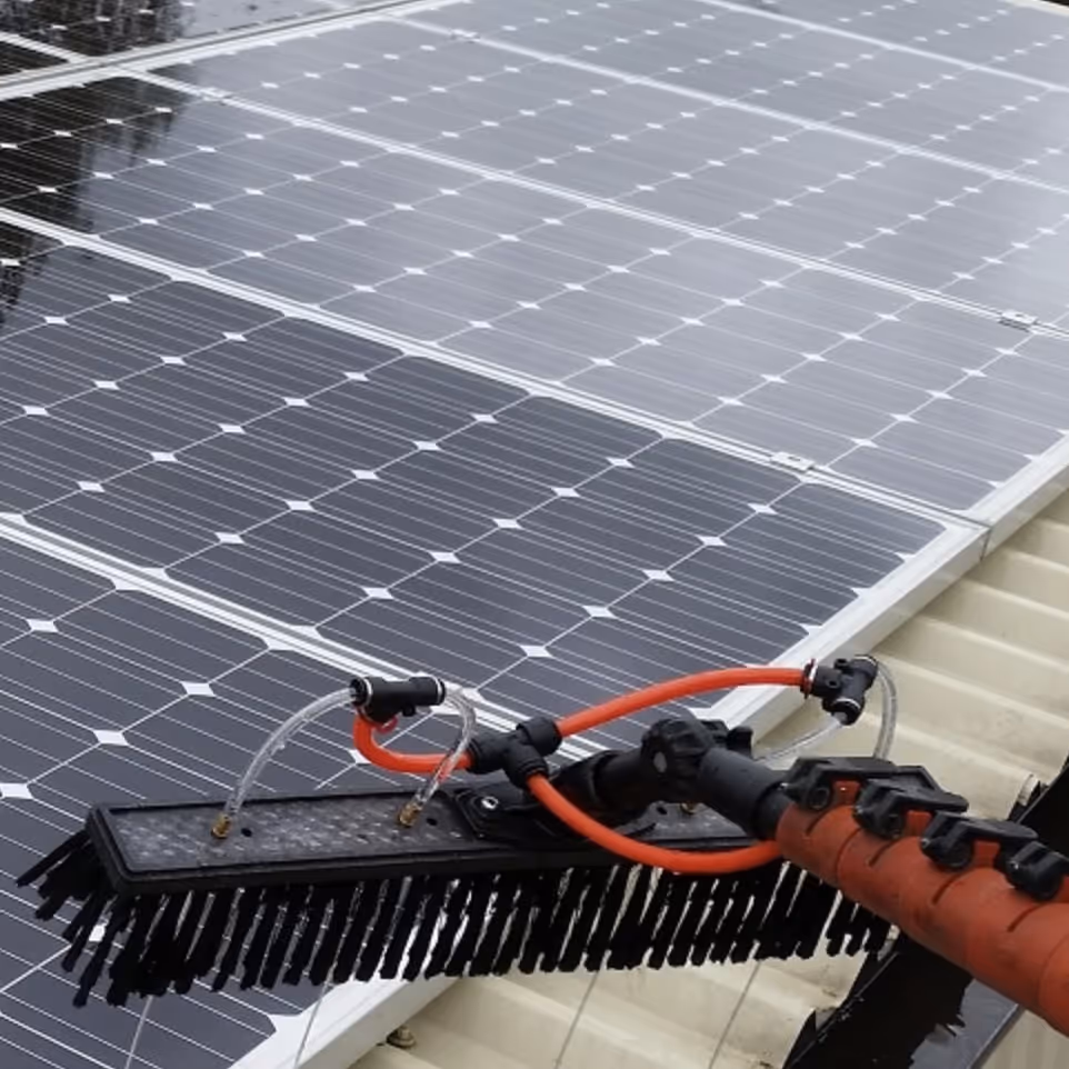 Cleaning solar panels on a roof