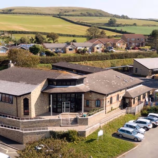 A modern school building in a countryside setting