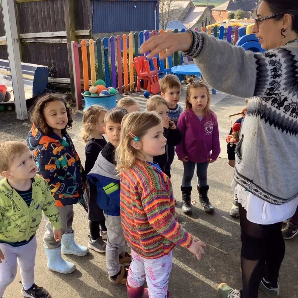 A teacher with kids in a school playground