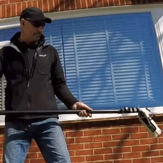 A man with window cleaning equipment