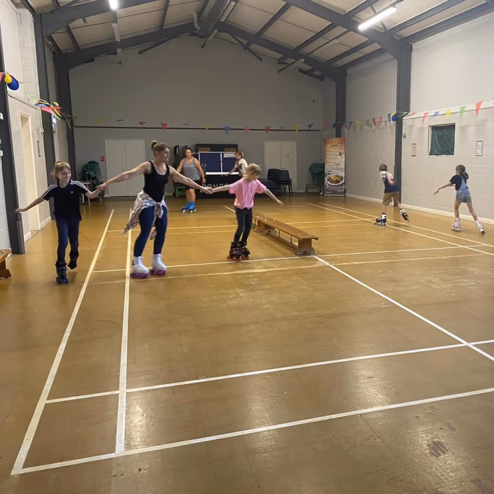People skating inside a community hall