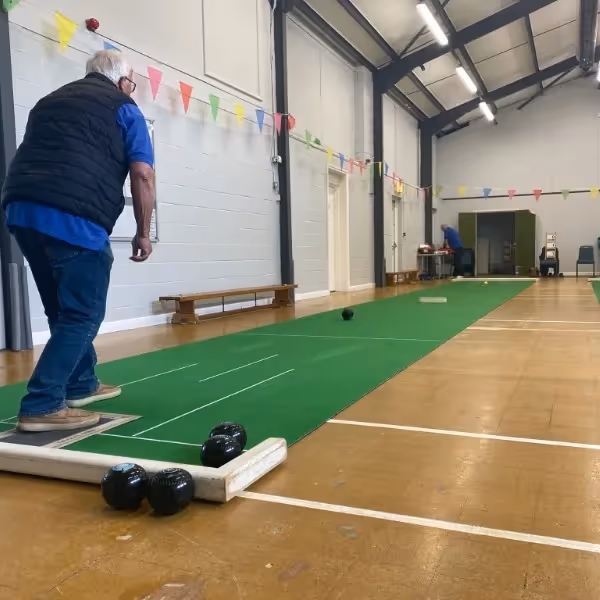 A man playing short mat bowls