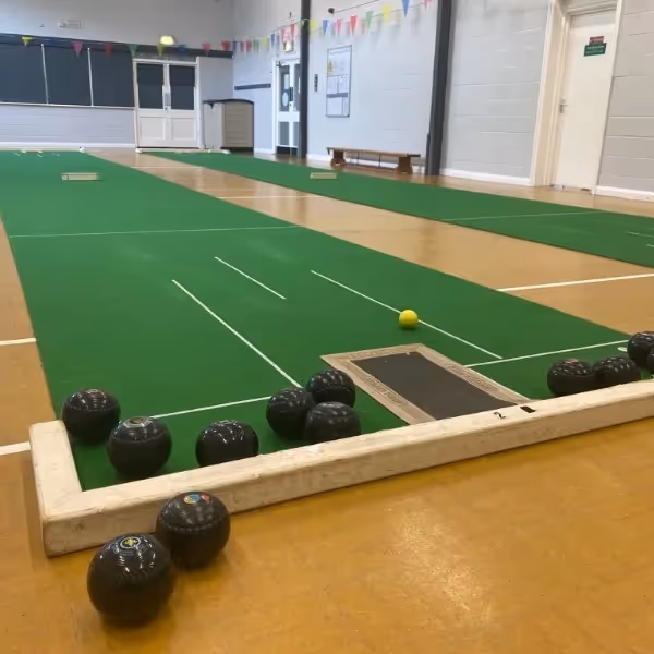 Short mat bowls set up inside a community hall