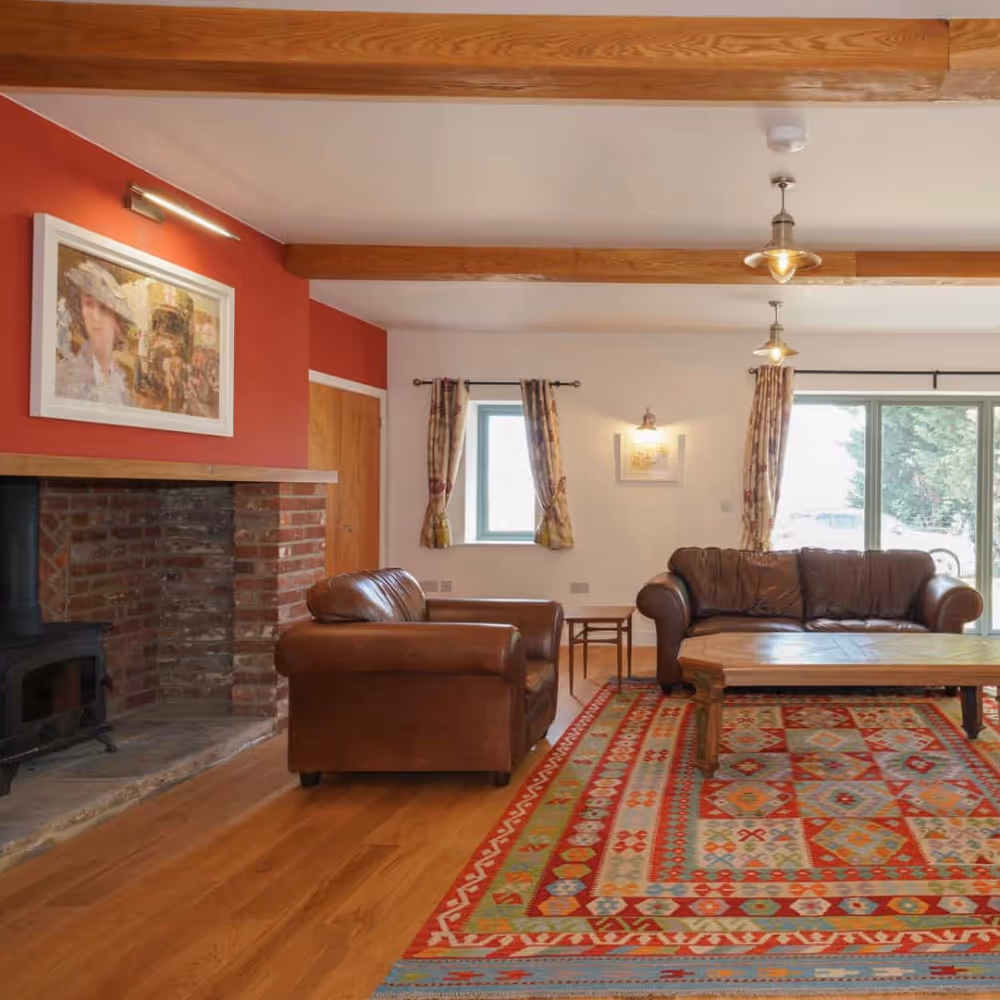 Interior of an old farmhouse with traditional sofas and red walls