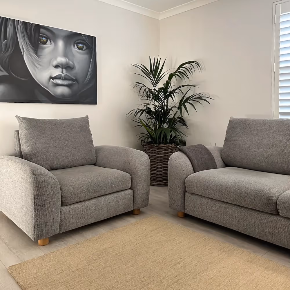 A white living room with modern grey sofas
