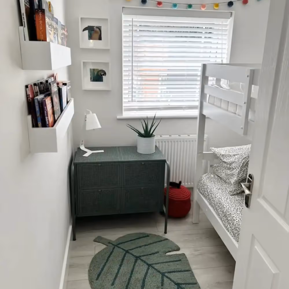 A white kids bedroom with green accents
