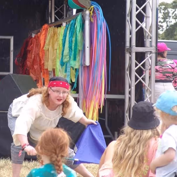 A teacher showing dance moves to kids