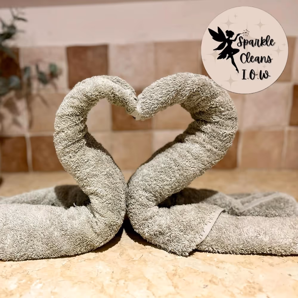 Two towels folded to resemble a pair of swans